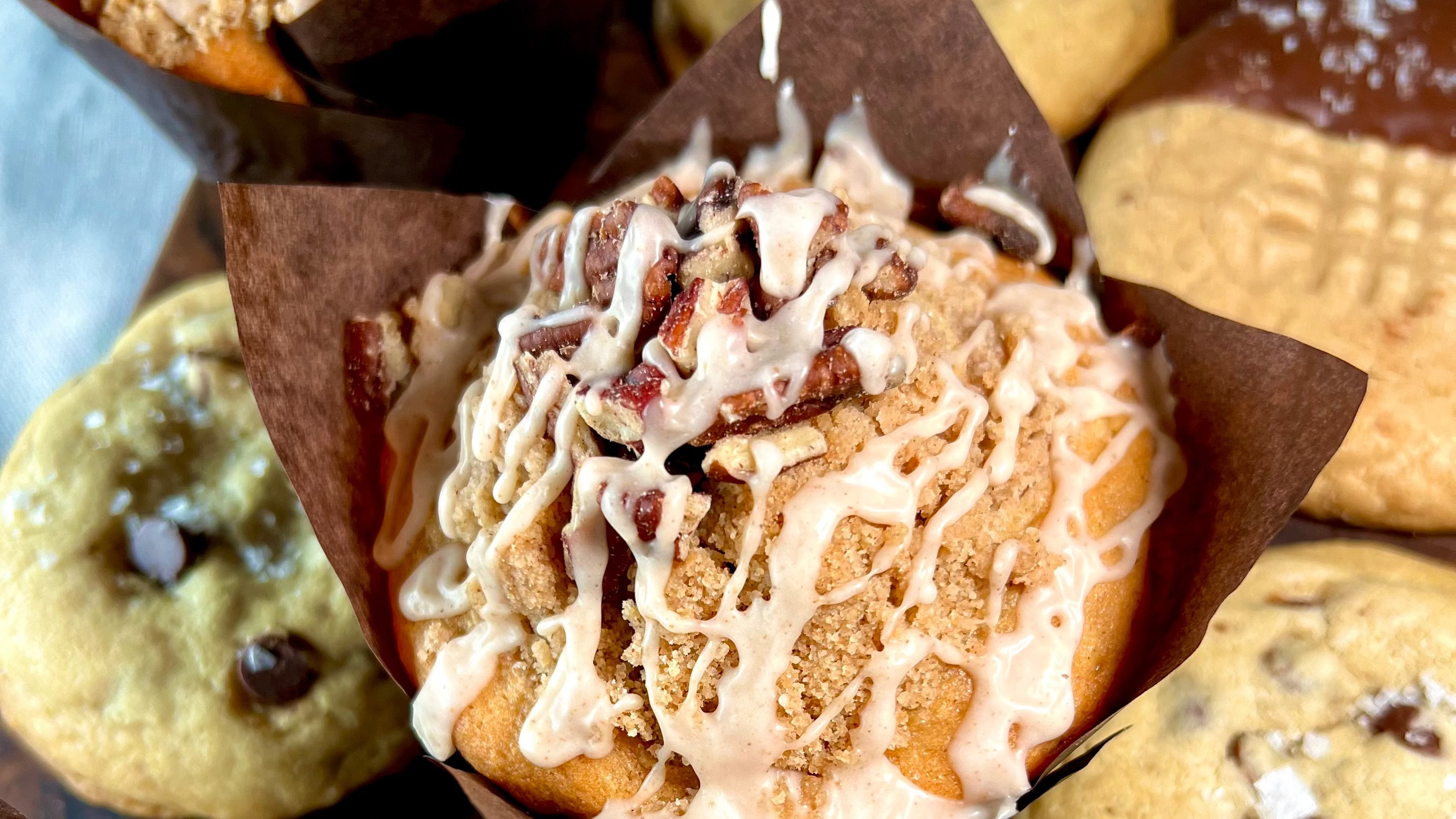 Assorted muffins with different toppings on a wooden board