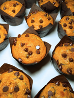 Pumpkin Chocolate Chip Muffins arranged on a white surface